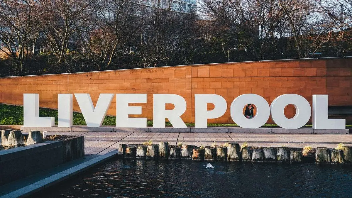 Large Liverpool sign near a water feature, symbolizing the vibrant city home to the University of Liverpool and its acceptance rate.