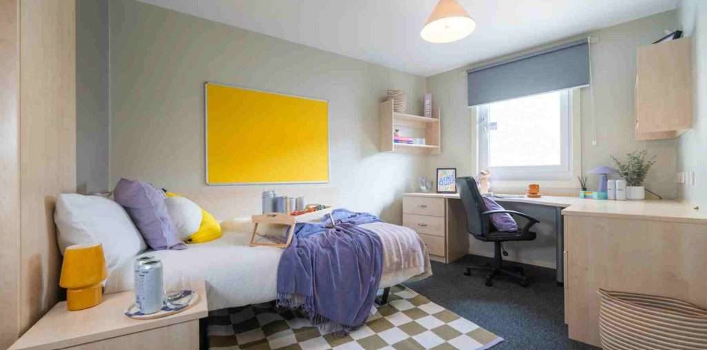 Student Accommodation Maintenance: Tenant Rights in UK 1 The image shows the image of a room with a blanket on the end of the bed and a chair for studies.
