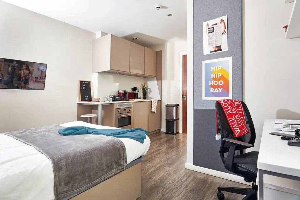 Student Accommodation Maintenance: Tenant Rights in UK 2 The image shows the image of a room with a blanket on the end of the bed and a chair for studies.