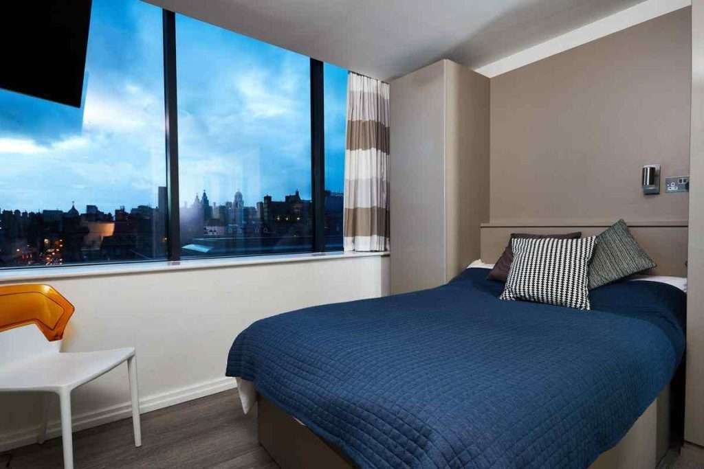 Student Accommodation Maintenance: Tenant Rights in UK 4 The image shows the image of a room with a blanket on the end of the bed and a chair for studies.